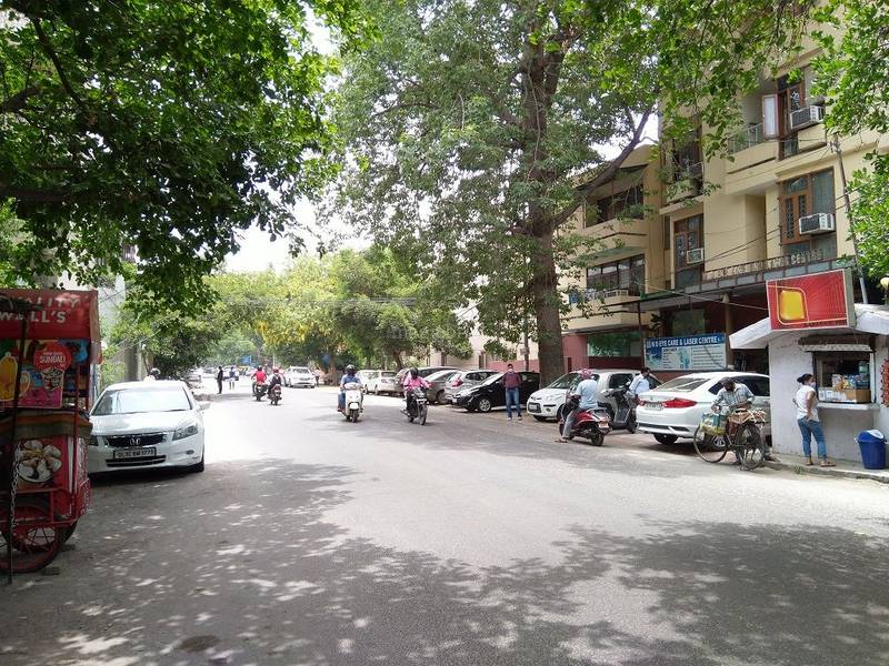 A shaded neighborhood street in Greater Kailash II, South Delhi