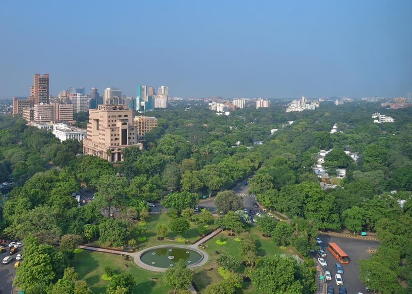 A wide view across South Delhi, with green canopy, buildings and a circular garden